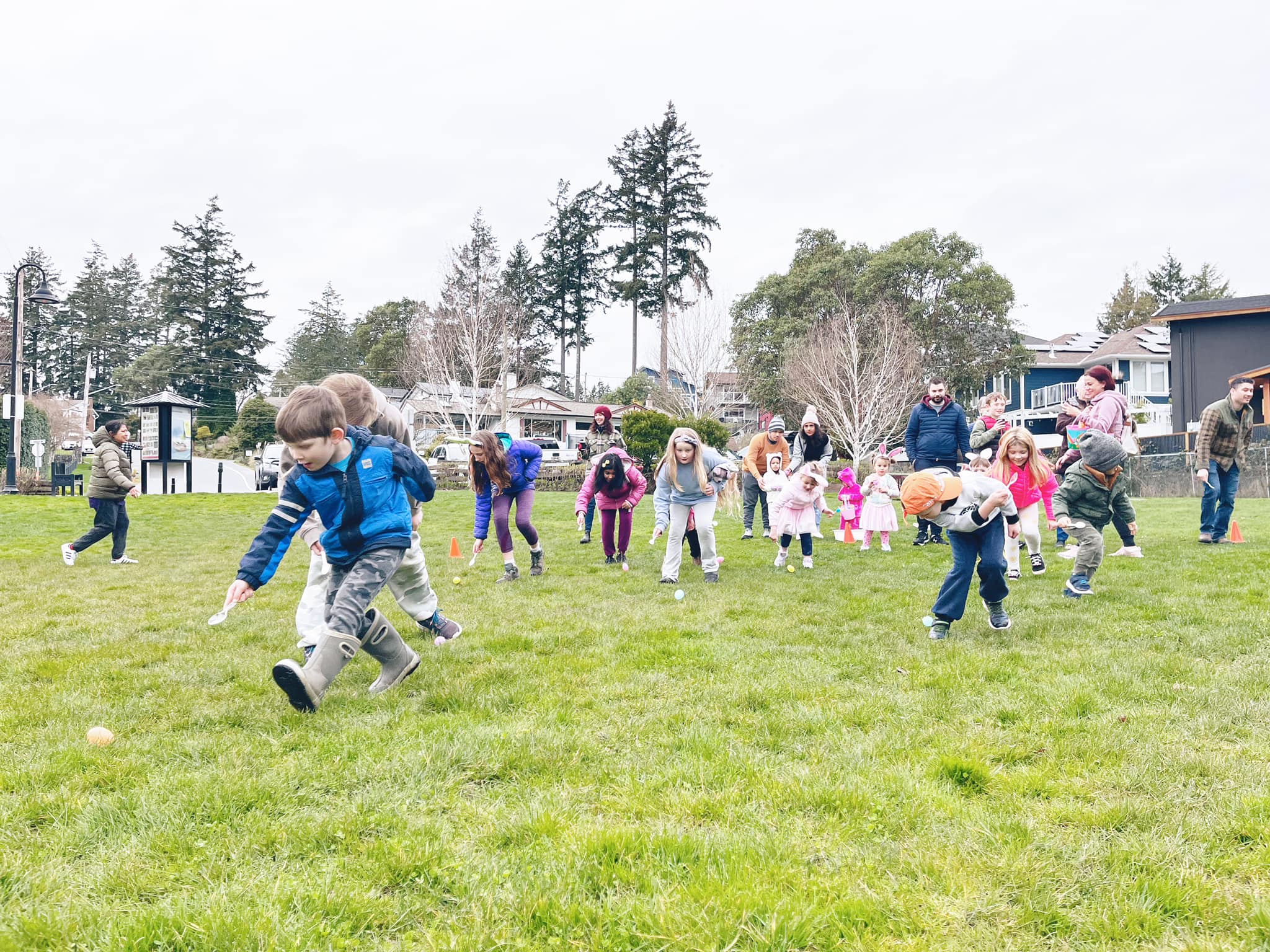 Children run for Easter Eggs spread on the ground in local park